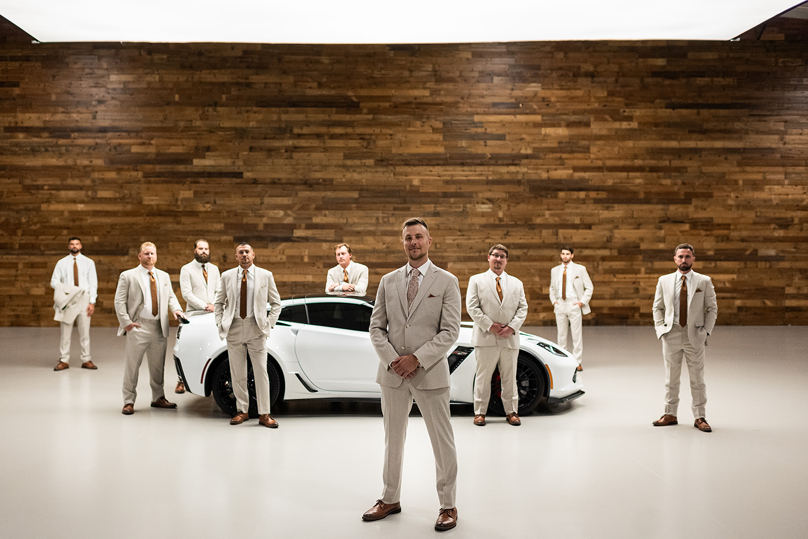 Groom and groomsmen portraits with a white corvette