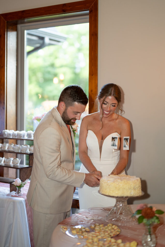 Bride and groom cutting into their wedding cake