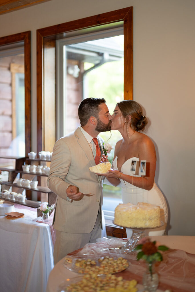 Bride and groom kissing after cake cutting