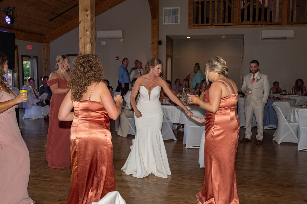 Bride and bridesmaids dancing