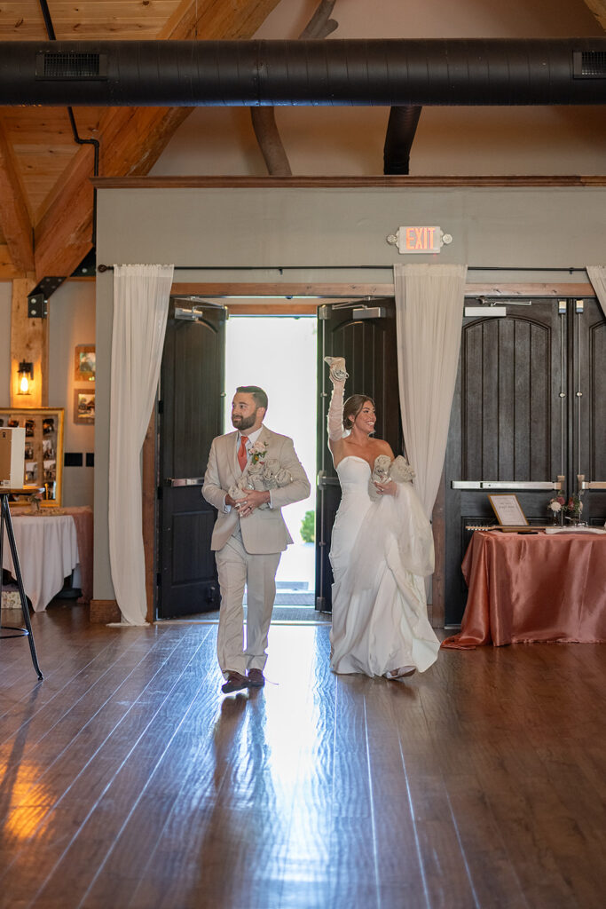 Bride and groom entering the reception