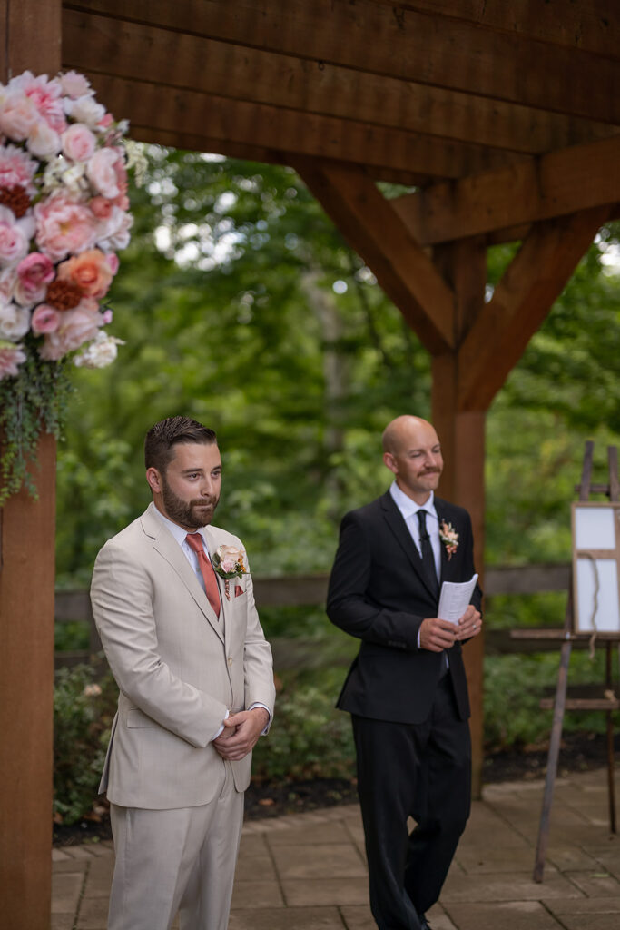 Groom watching his bride walk down the aisle