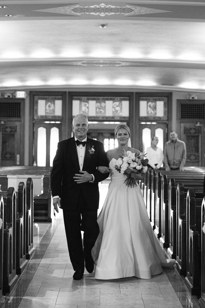 Bride being walked down the aisle by her father