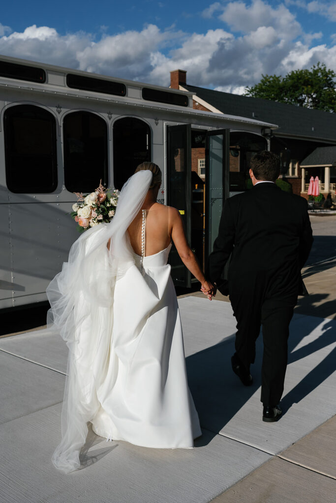 Bride and groom holding hands and walking to the trolley after their Chicago wedding ceremony