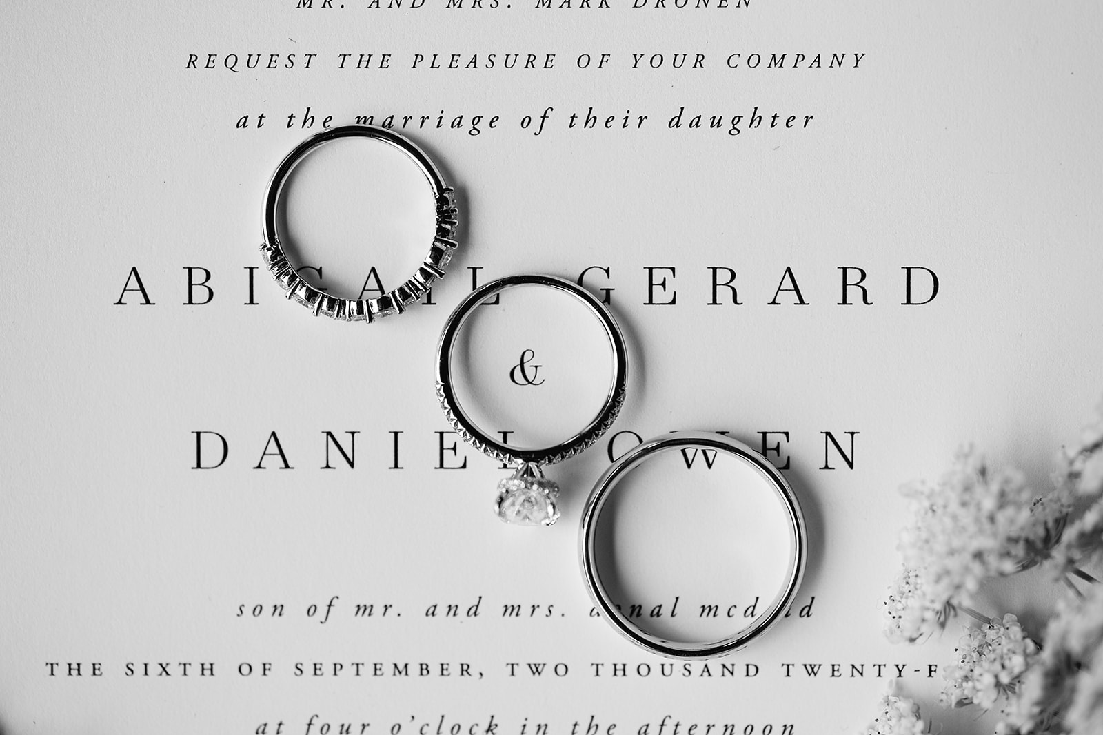 Wedding detail shot with rings on the wedding invitations