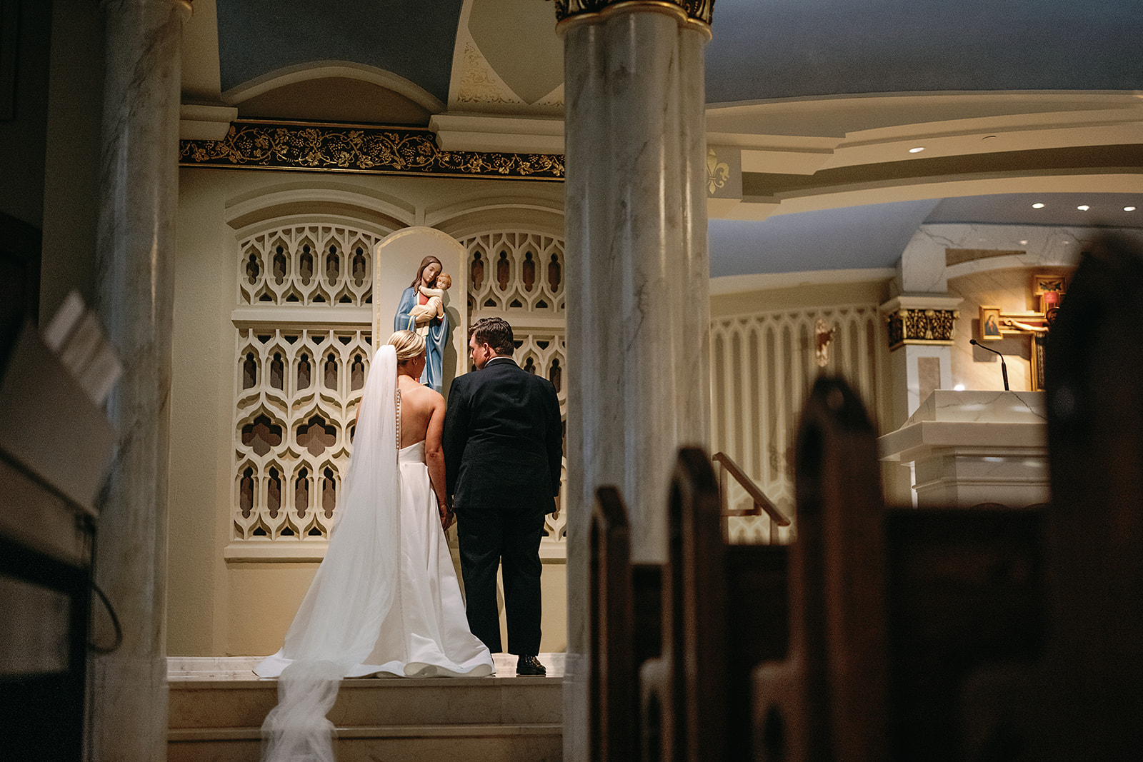 Bride and groom praying during their Catholic wedding ceremony