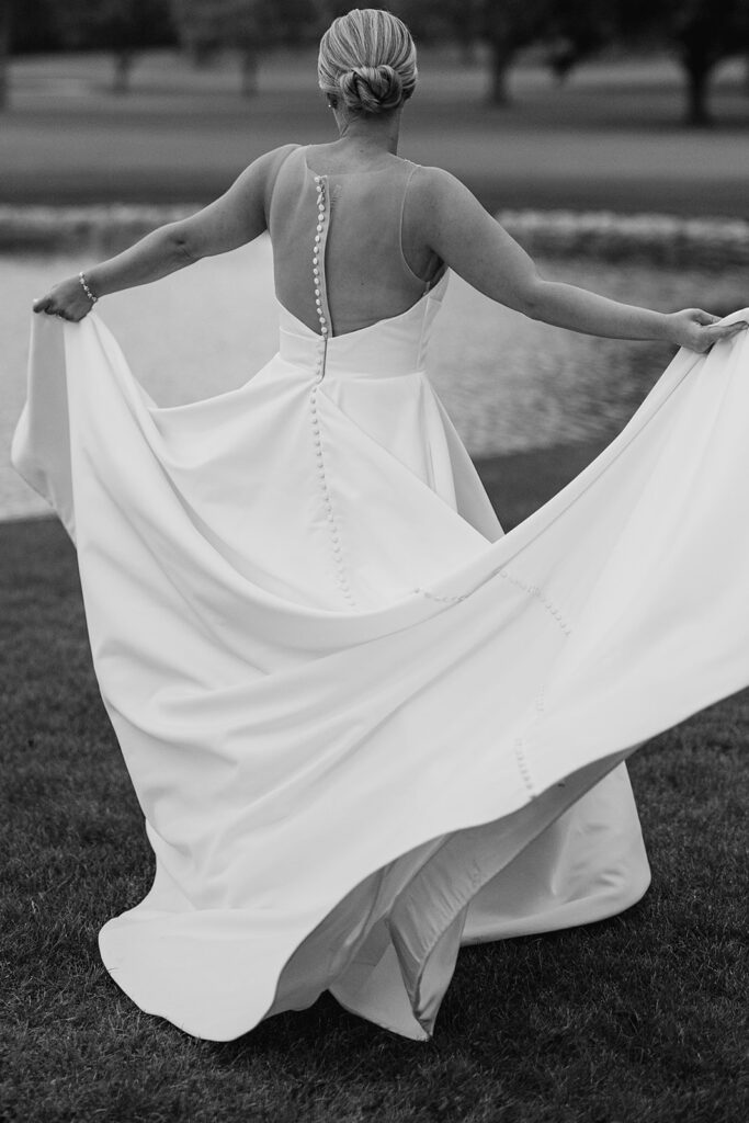 Black and white photo of a bride dancing at River Forest Country Club wedding venue in Chicago