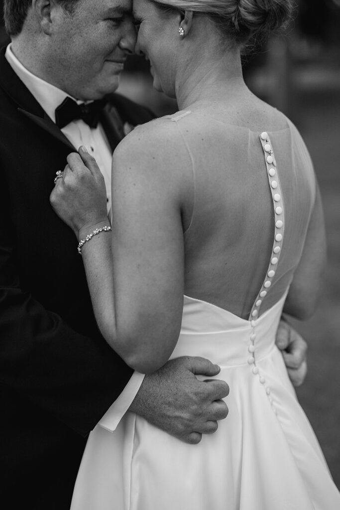 Close up shot of a bride and groom touching noses and embracing each other