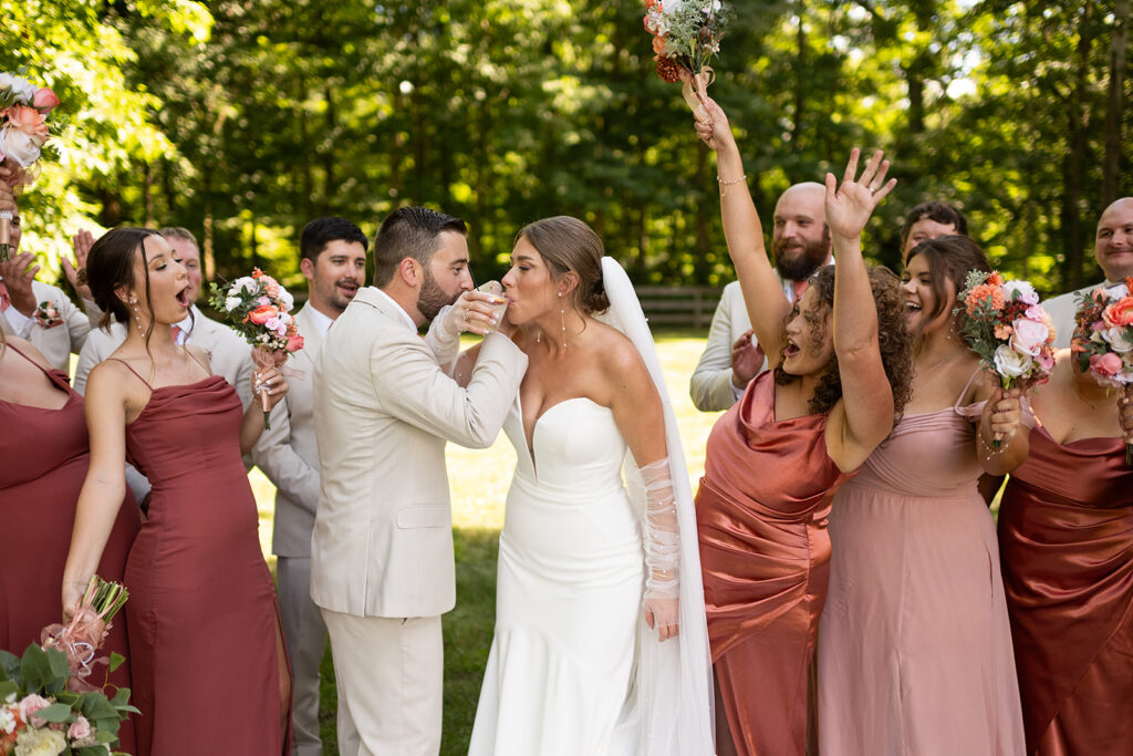 Full wedding party photos outside of Stone Creek Lodge wedding venue in Indiana