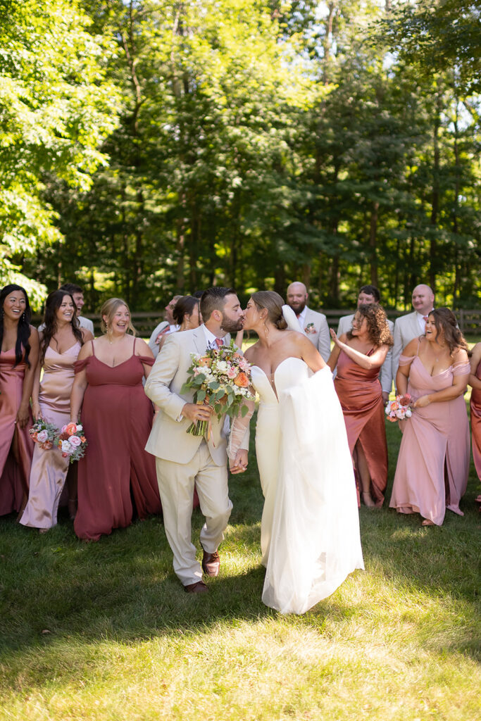 Bride and groom kissing during their Stone Creek Lodge wedding party photos