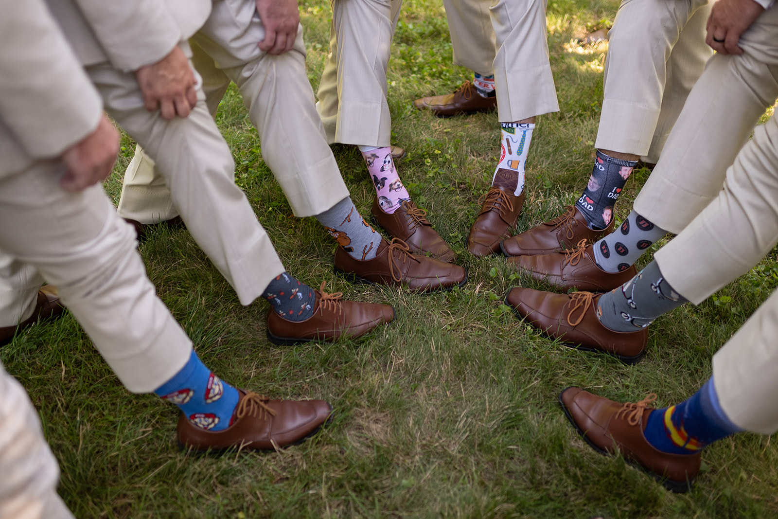 Groom and groomsmen showing off their matching socks