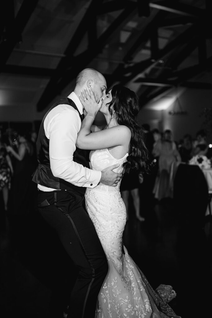 Bride and groom kissing on the dance floor