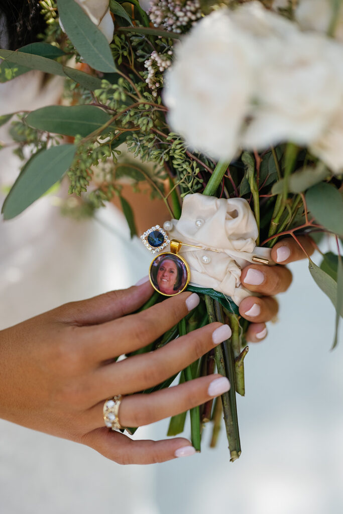 Bride holding her wedding bouquet with memory charms 