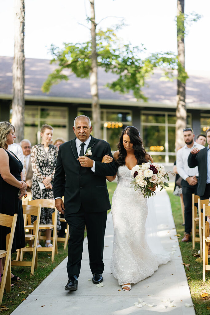 Bride being walked down the aisle by her father