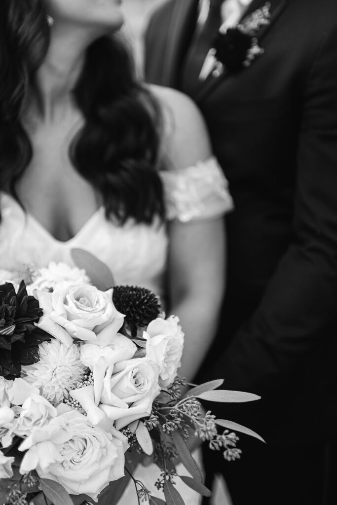 Close up black and white photo of a bride and groom posing together