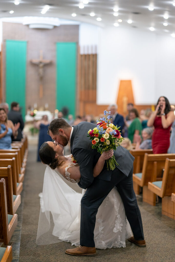 Bride and groom doing a dip kiss at the end of their ceremony