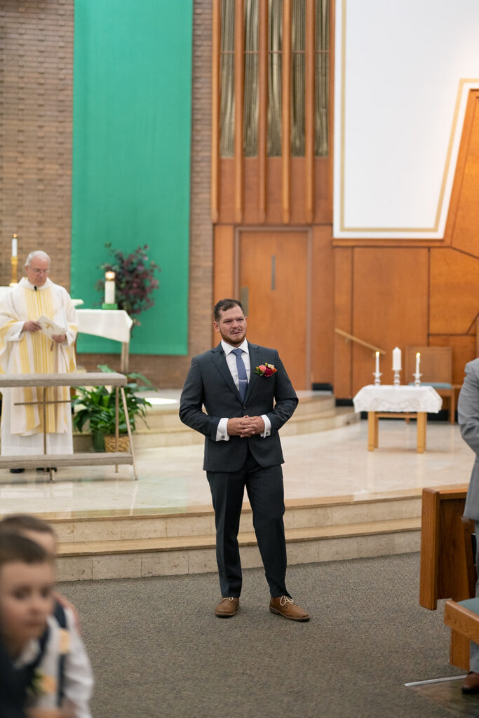 Groom getting emotional as he sees his bride walking the the aisle