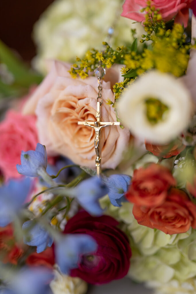 Colorful summer wedding bouquet with a cross from a catholic wedding in Chicago