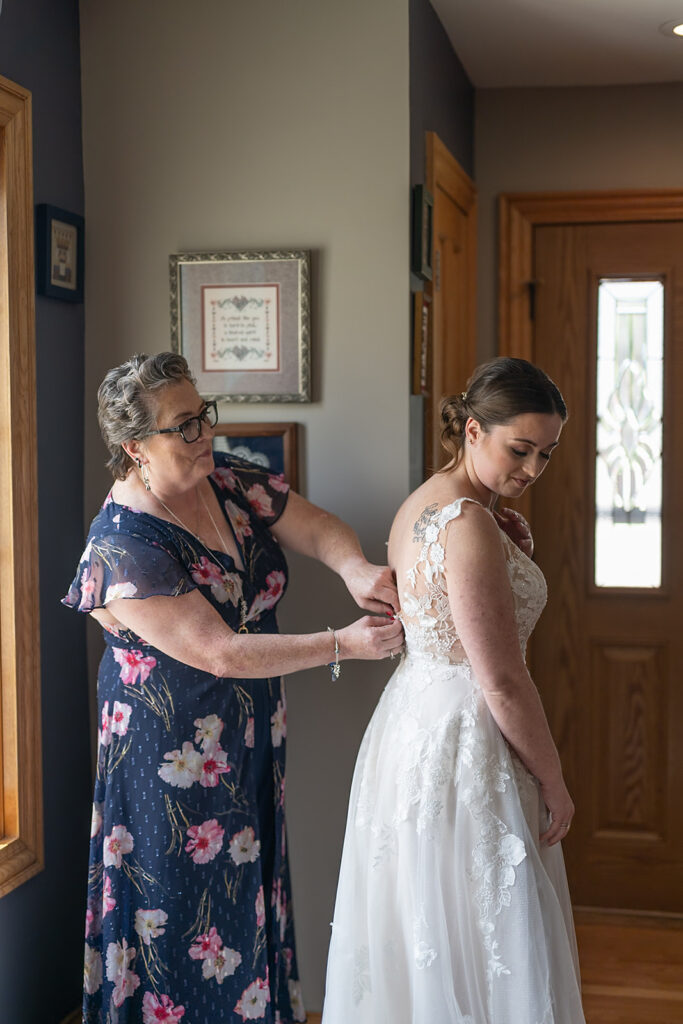 Bride getting her dress zipped up