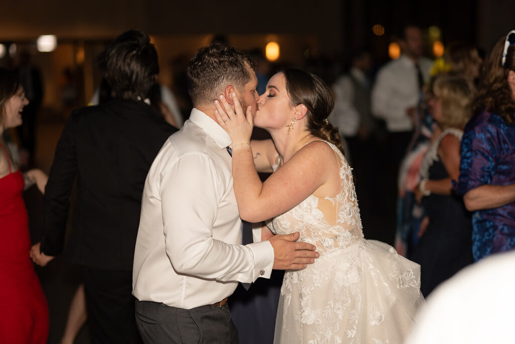 Bride and groom kissing at the end of the night