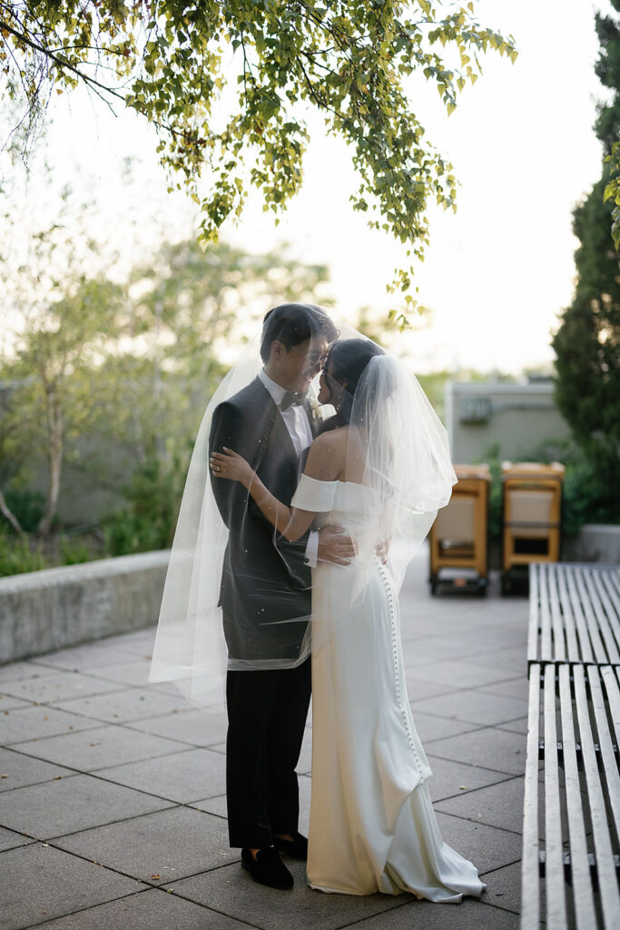 Bride and groom posing outdoors for their Greenhouse Loft Chicago wedding portraits