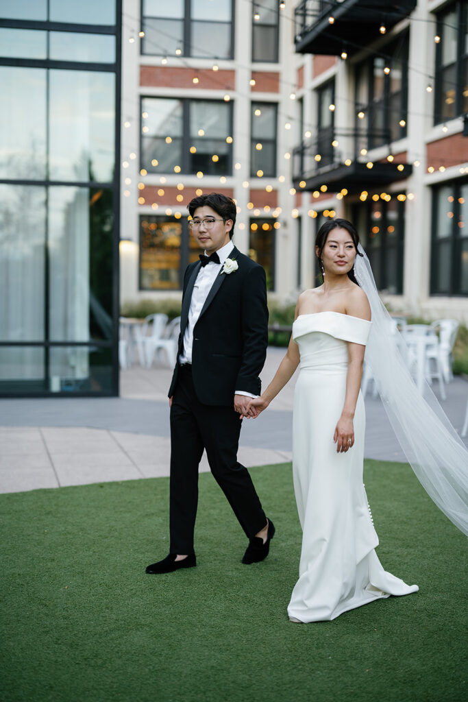 Bride and groom posing outdoors for their Greenhouse Loft Chicago wedding portraits