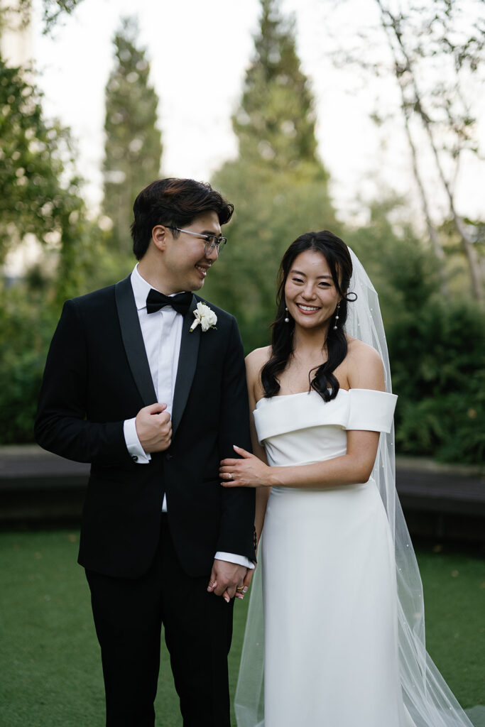 Bride and groom posing outdoors for their Greenhouse Loft Chicago wedding portraits