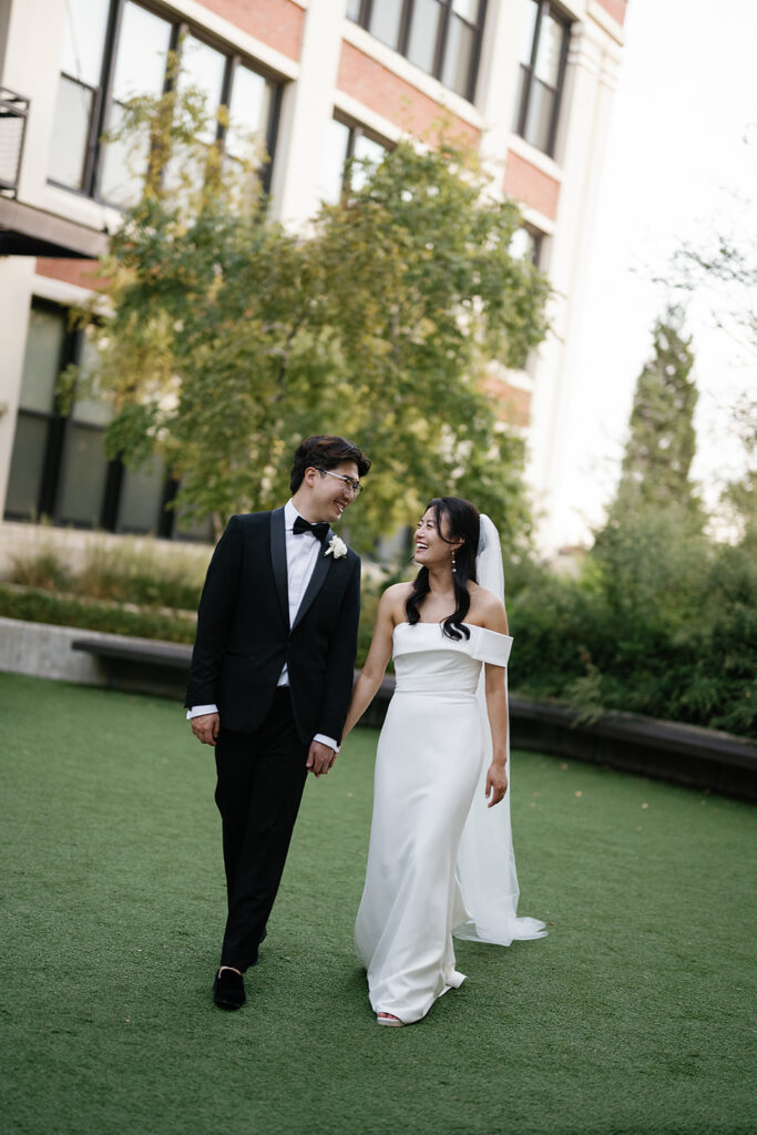 Bride and groom posing outdoors for their Greenhouse Loft Chicago wedding portraits