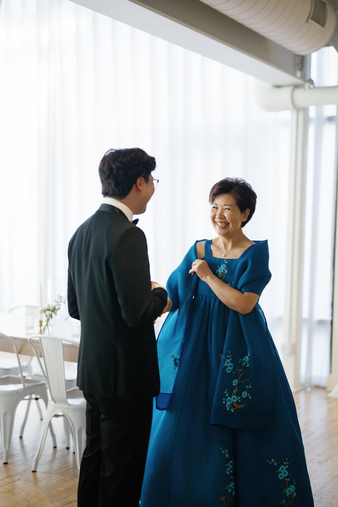 Groom sharing a first look with his mother during his Greenhouse Loft Chicago wedding