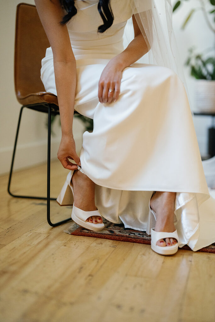 Bride putting her wedding shoes on