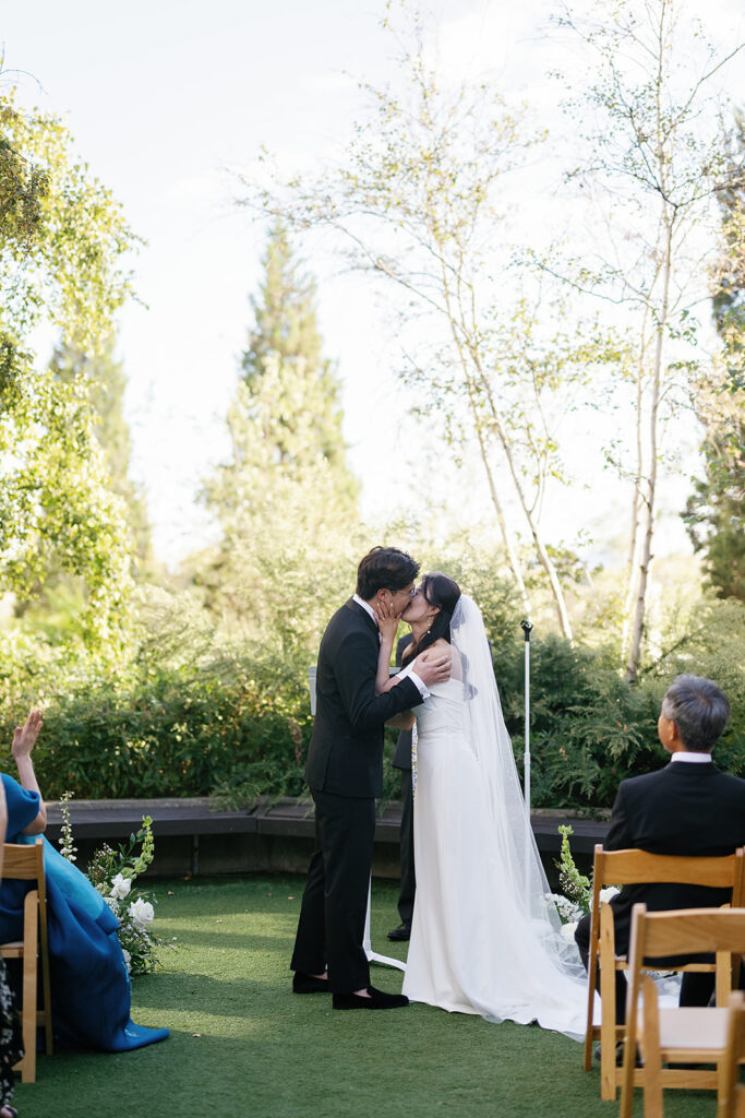 Bride and groom kissing after their Greenhouse Loft Chicago wedding ceremony