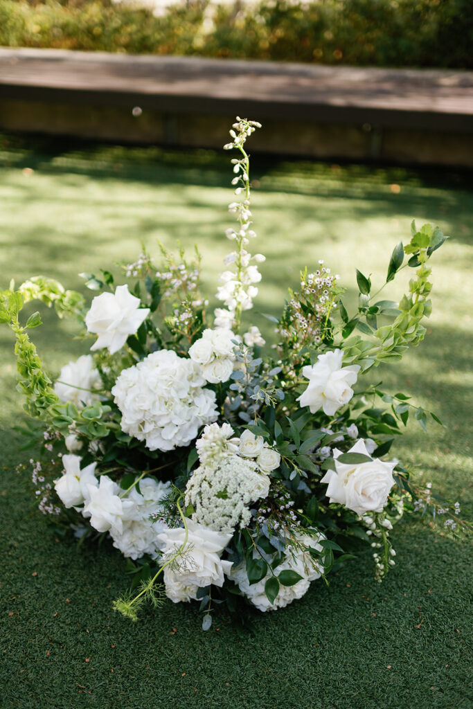 Lush white wedding ceremony florals