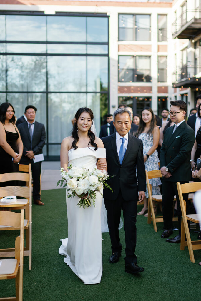 Bride being walked down the aisle by her father