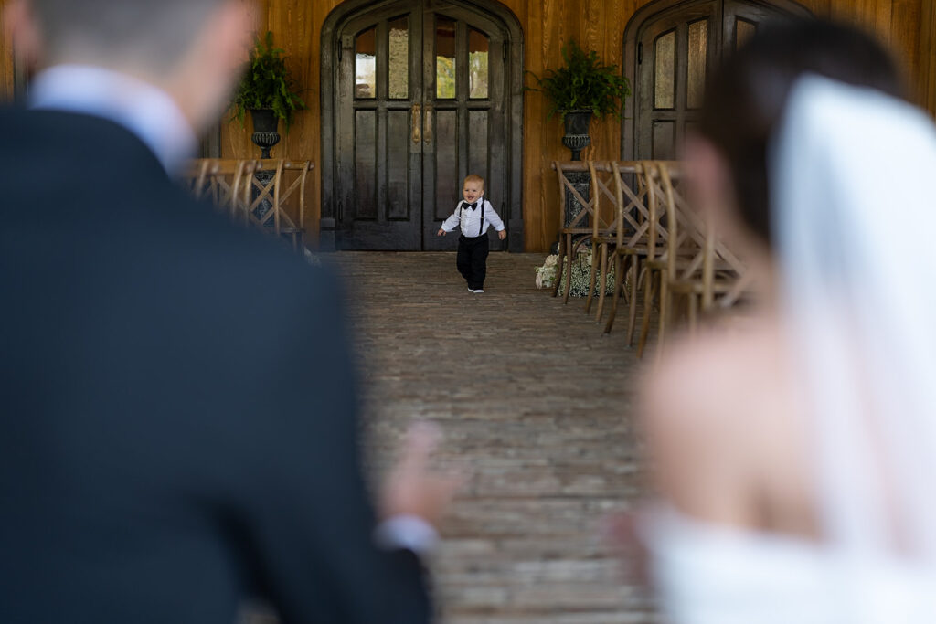 Bride and groom welcoming their small son in for a hug