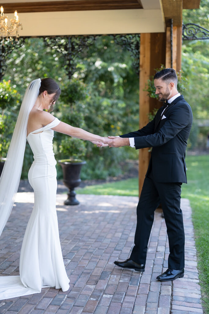 Groom looking at his bride during their first look