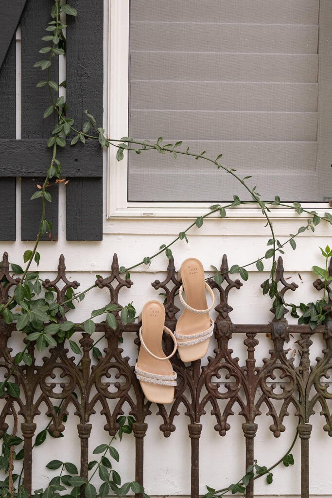 Brides heels hanging off an iron fence