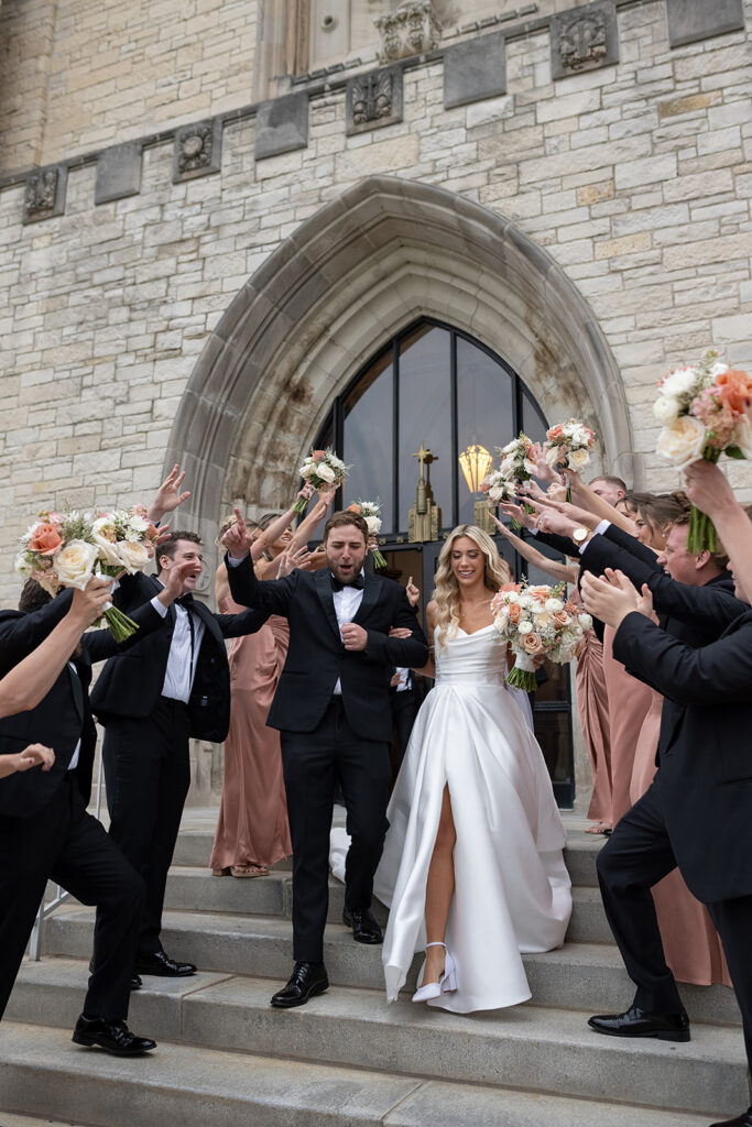 Bride and grooms church exit after their Immaculate Conception Fort Wayne wedding ceremony