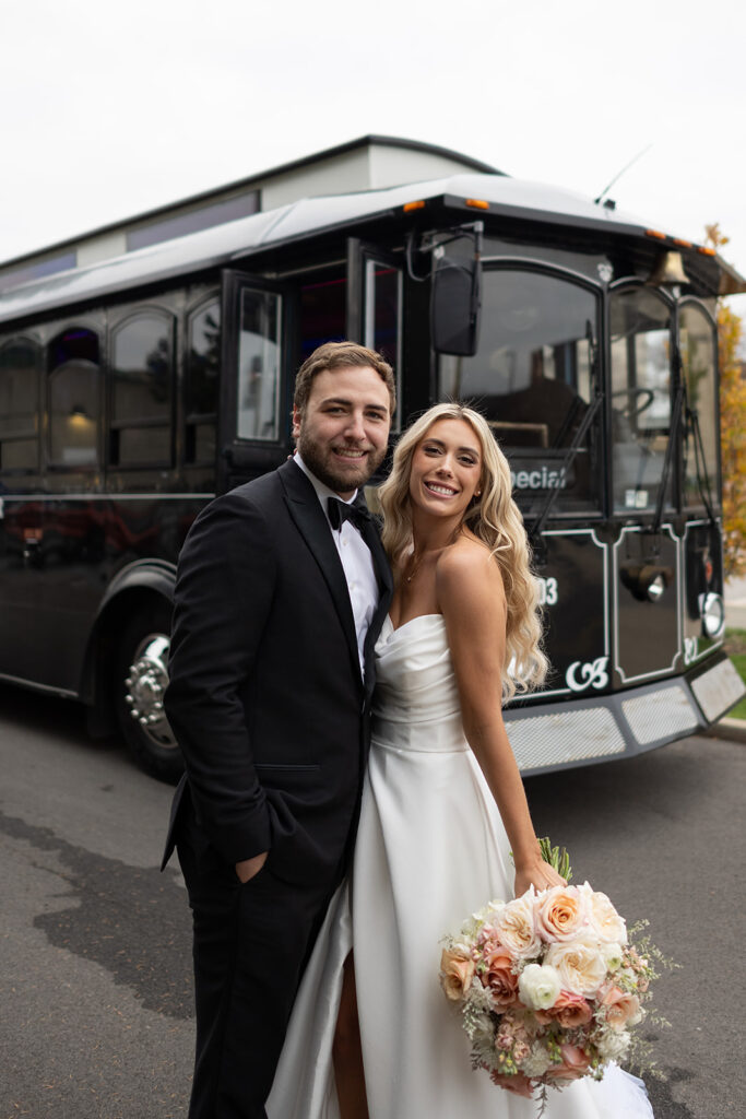 Bride and groom posing with a trolley during their Fort Wayne, Indiana wedding portraits