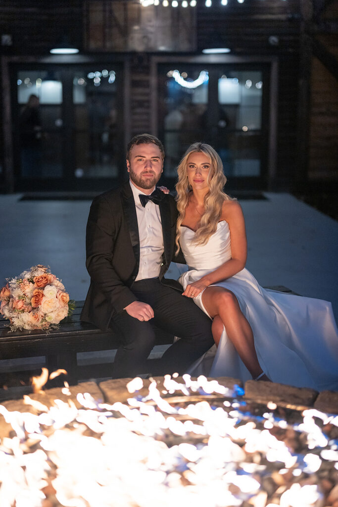 Bride and groom sitting by the fire during their Union 12 wedding in Fort Wayne, Indiana