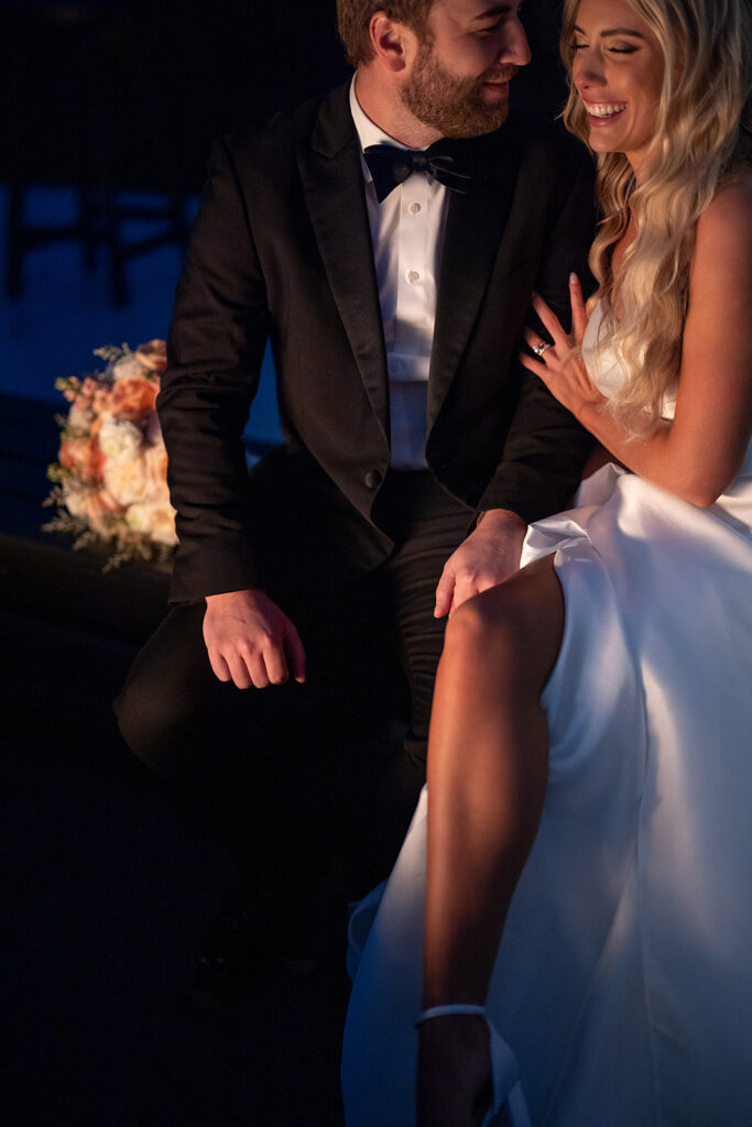 Bride and groom sitting by the fire during their Union 12 wedding in Fort Wayne, Indiana