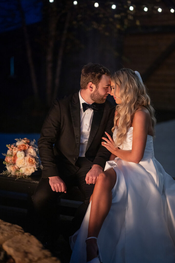 Bride and groom sitting by the fire during their Union 12 wedding in Fort Wayne, Indiana