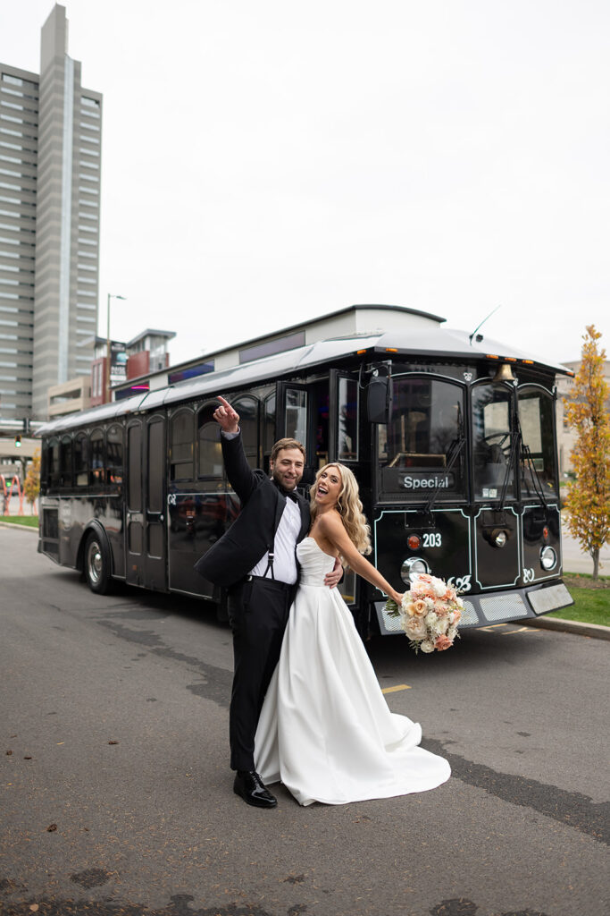 Bride and groom posing with a trolley during their Fort Wayne, Indiana wedding portraits