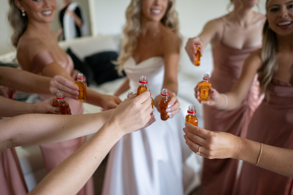 Bride and bridesmaids taking shots of Fireball before the ceremony