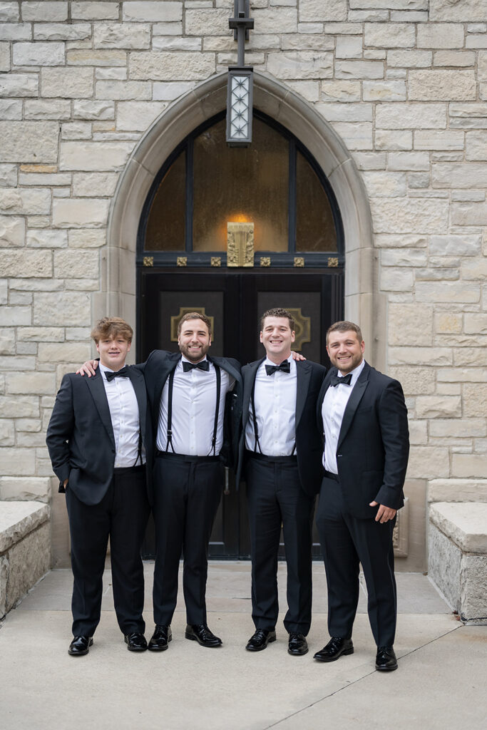 Groom and groomsmen portraits outside of Cathedral of Immaculate Conception in Fort Wayne, Indiana