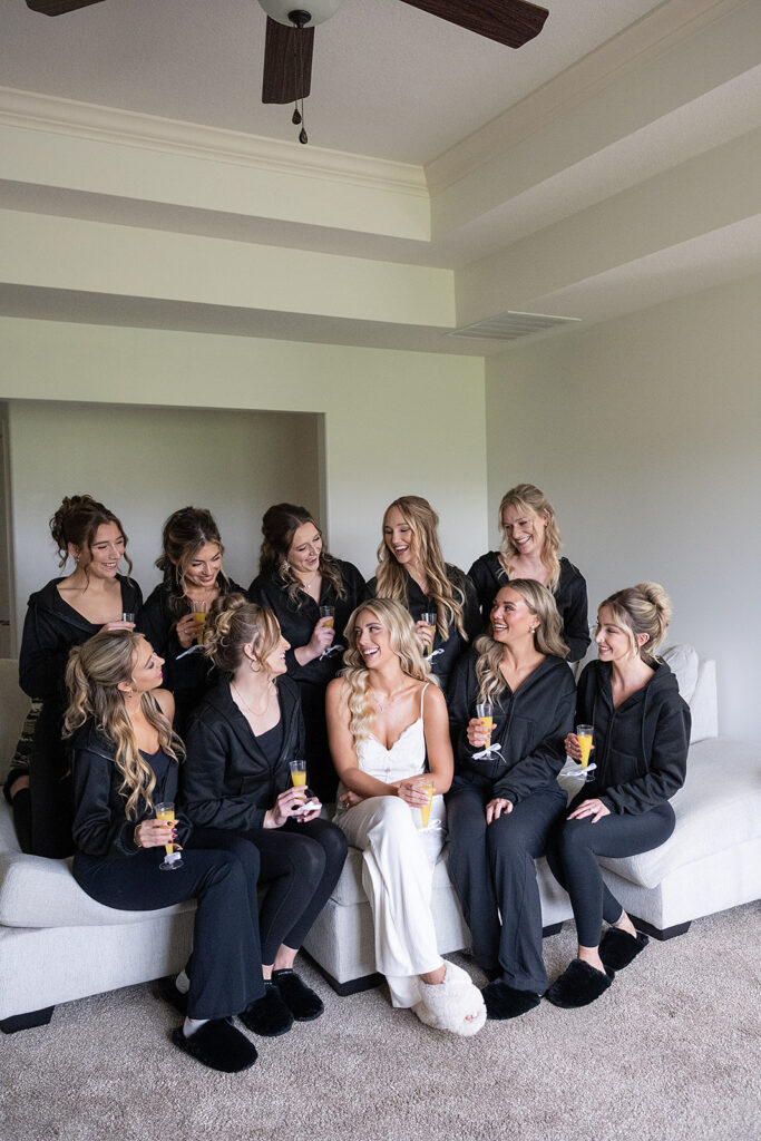 Bride and her bridesmaids drinking mimosas