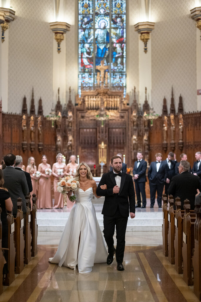 Bride and groom walking back down the aisle during their Immaculate Conception Fort Wayne wedding ceremony