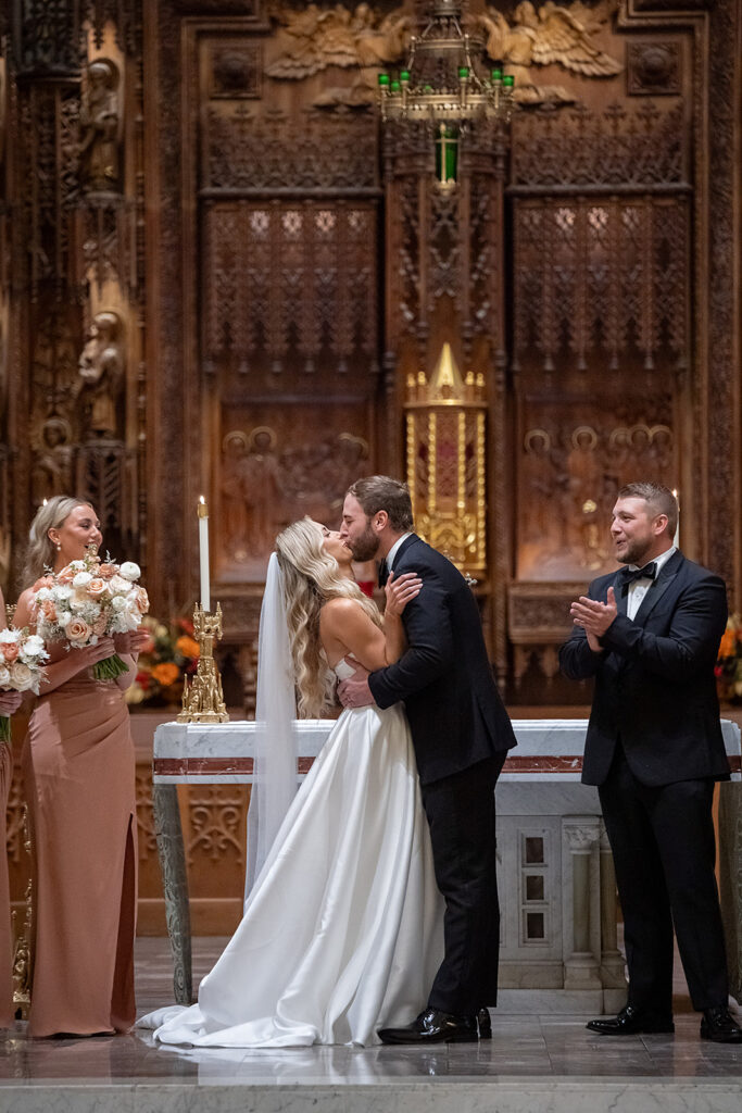 Bride and groom kissing during their Immaculate Conception Fort Wayne wedding ceremony