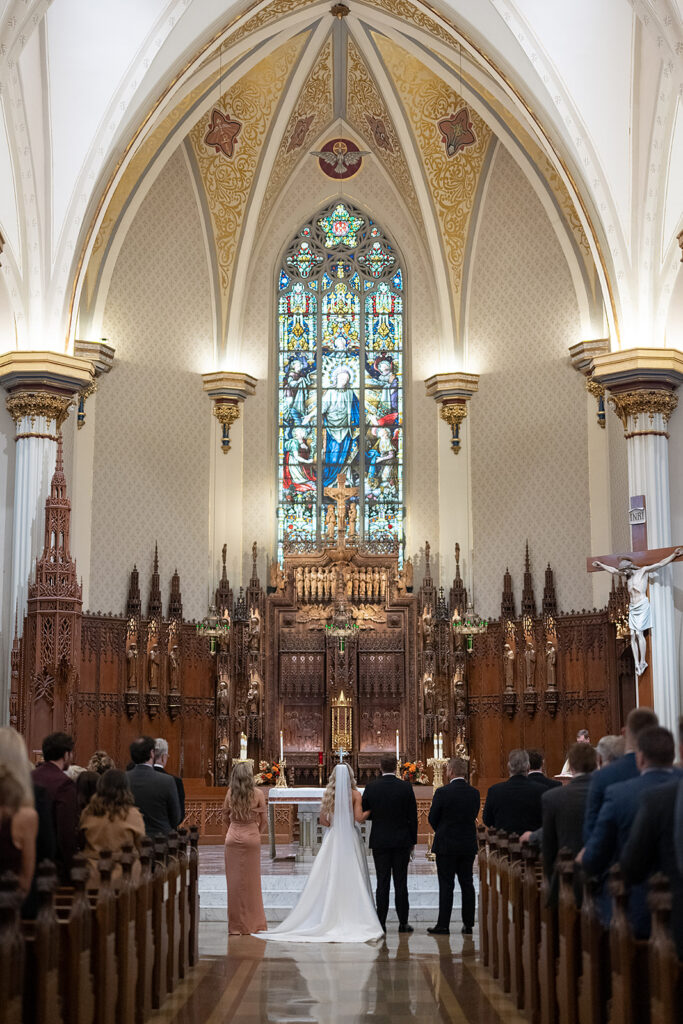 Bride and groom standing at the altar for their Immaculate Conception Fort Wayne wedding ceremony