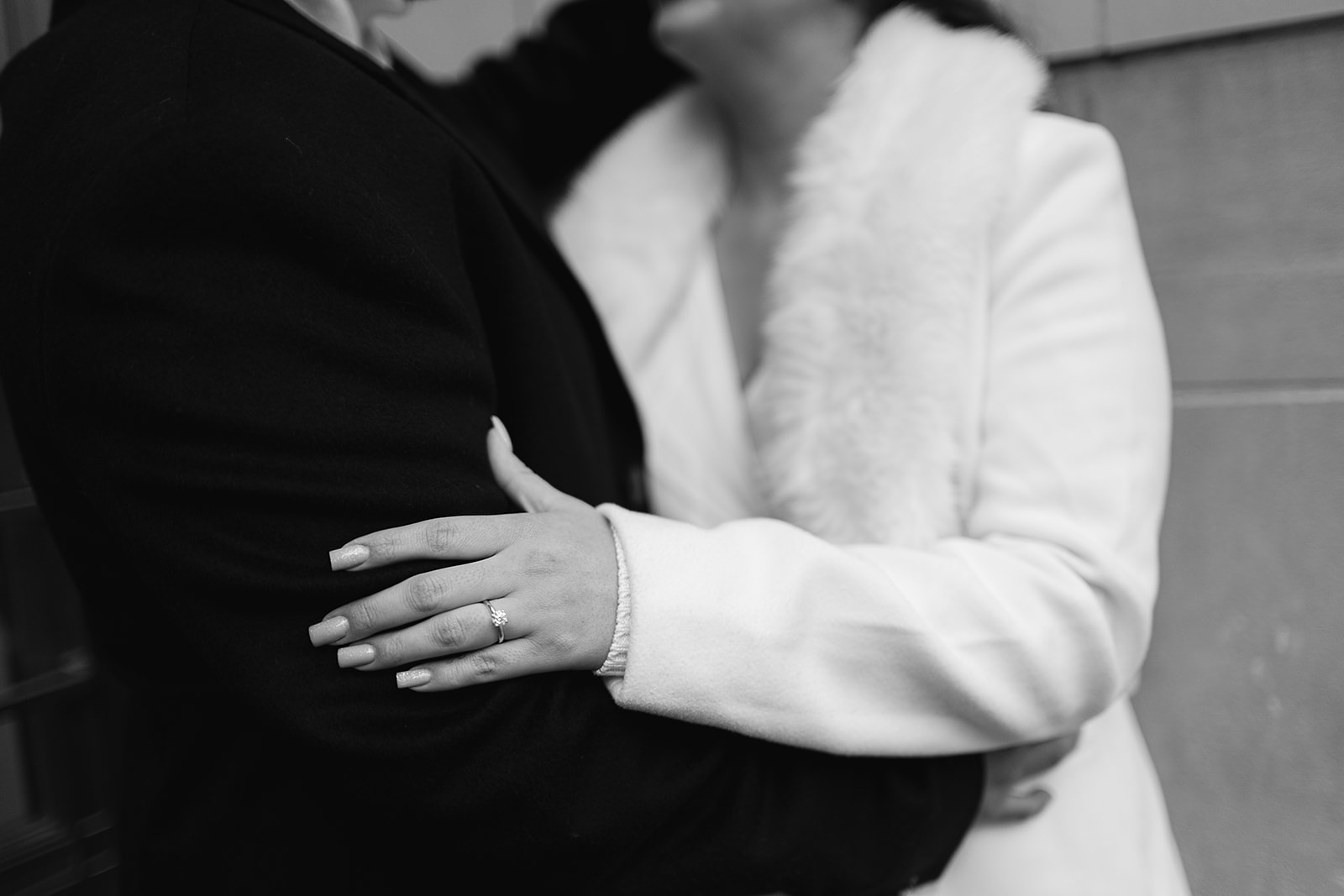 Black and white engagement photo showing off the engagement ring