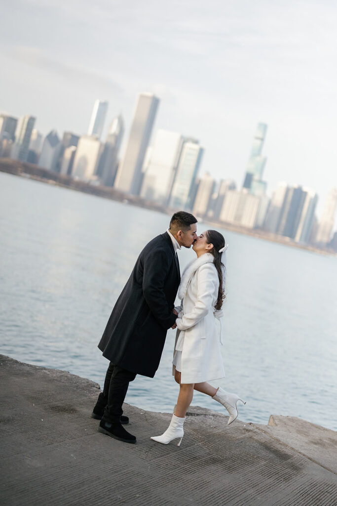 Couple kissing with skyline views of Chicago behind them